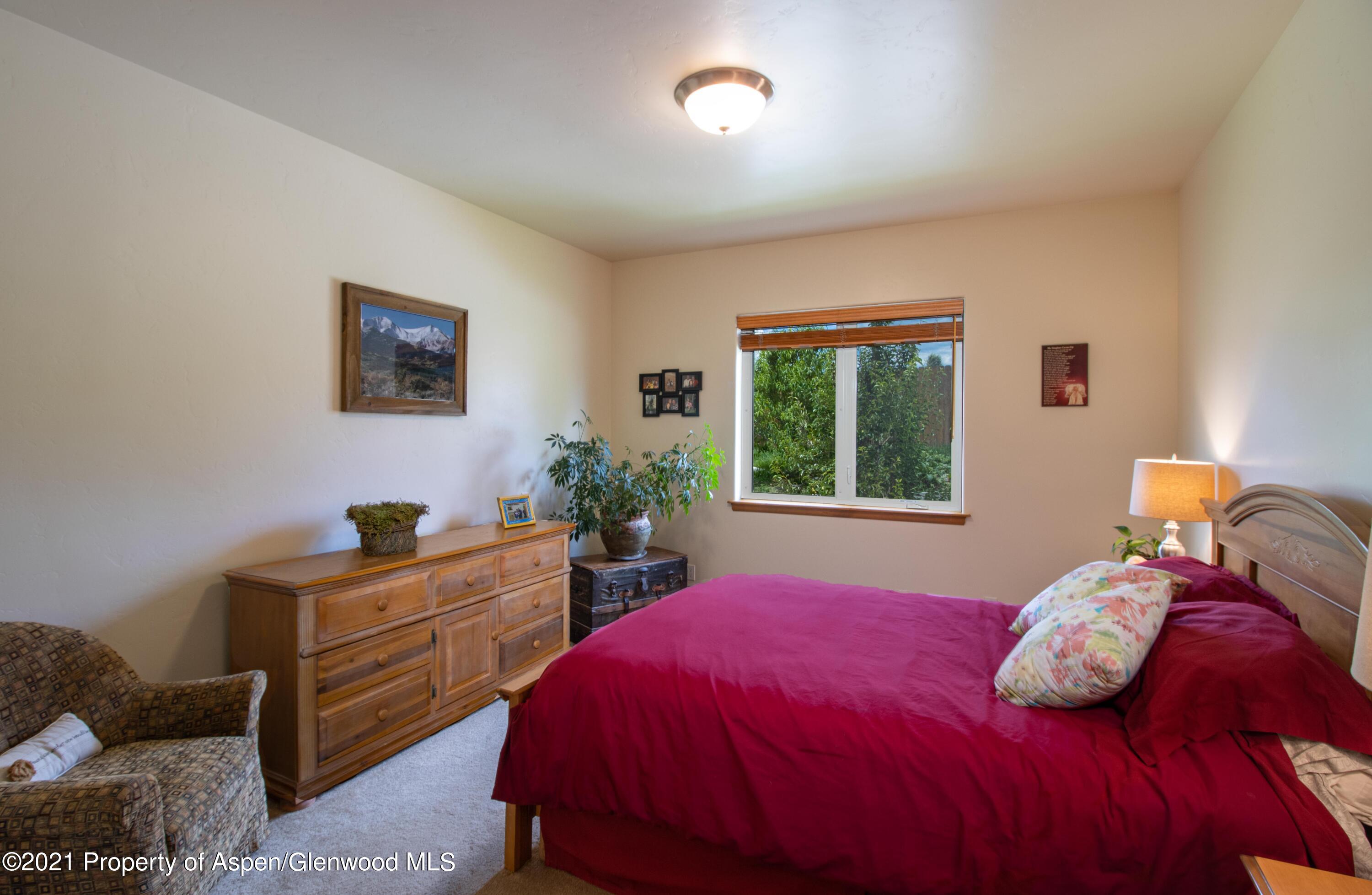 1904 Promontory Circle Rifle, CO 81650 - Photo 9 of 20 a bedroom with a bed and a window