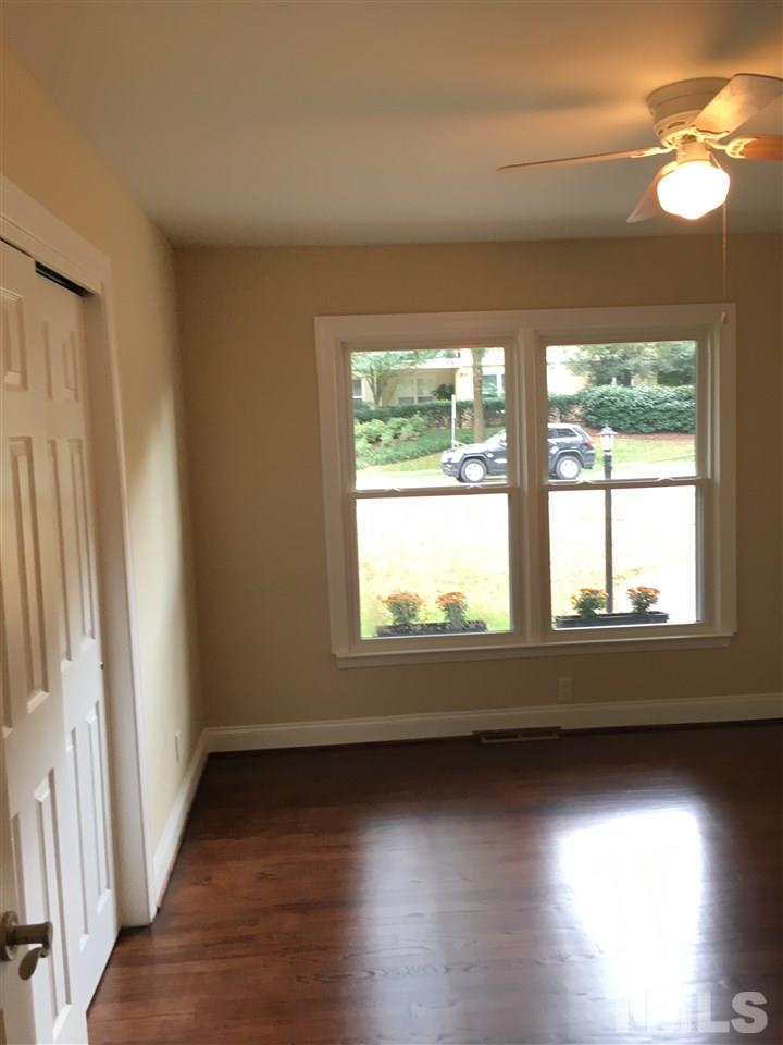 4301 Rowan Street Raleigh, NC 27609 - Photo 11 of 20 a view of an empty room with wooden floor and a window