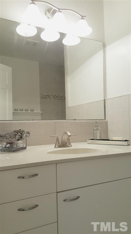 4301 Rowan Street Raleigh, NC 27609 - Photo 12 of 20 a bathroom with a sink and a mirror
