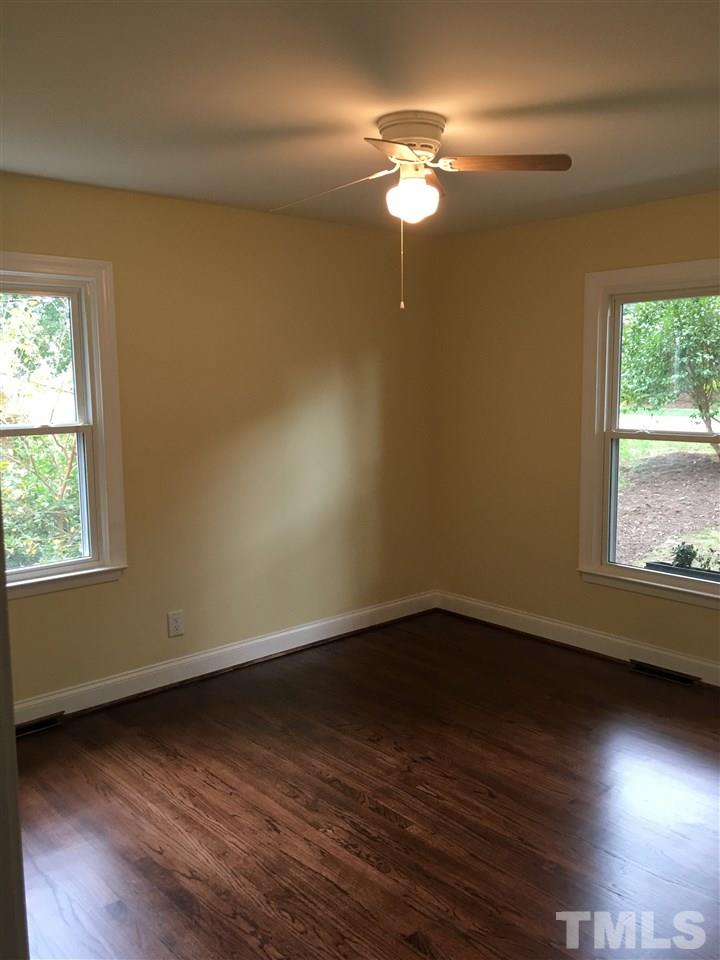 4301 Rowan Street Raleigh, NC 27609 - Photo 14 of 20 an empty room with wooden floor and windows