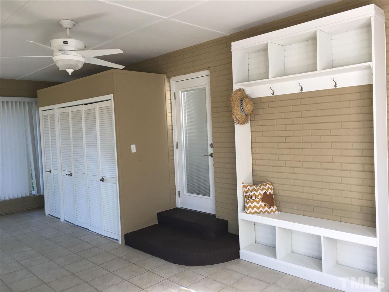 4301 Rowan Street Raleigh, NC 27609 - Photo 16 of 20 a view of a hallway with a cabinet and a mirror