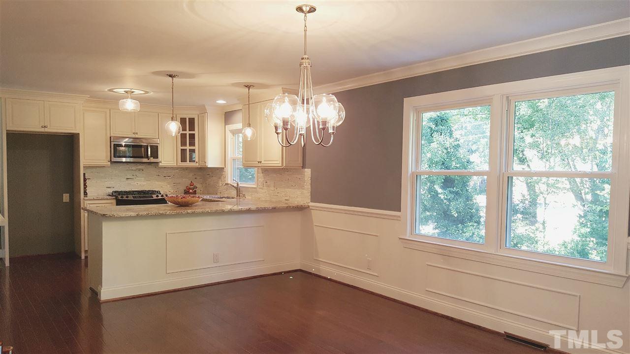 4301 Rowan Street Raleigh, NC 27609 - Photo 6 of 20 a kitchen with granite countertop a sink cabinets and stainless steel appliances