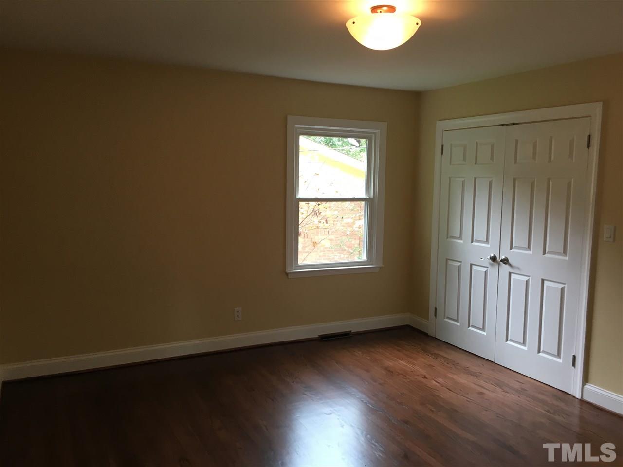 4301 Rowan Street Raleigh, NC 27609 - Photo 9 of 20 an empty room with wooden floor and windows