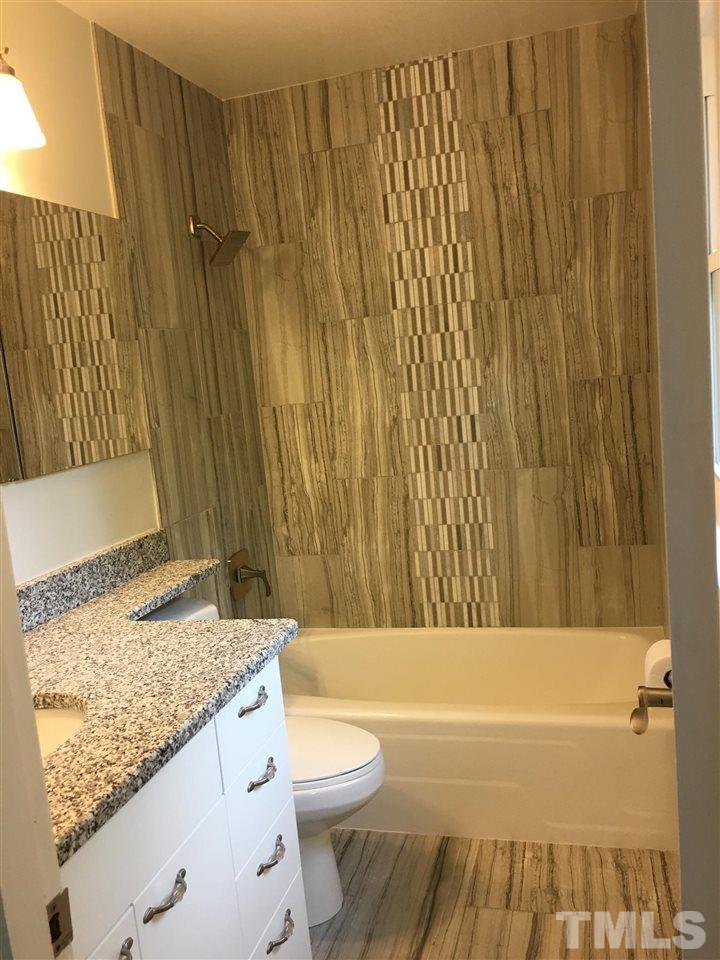 4301 Rowan Street Raleigh, NC 27609 - Photo 10 of 20 a bathroom with a granite countertop sink toilet and shower