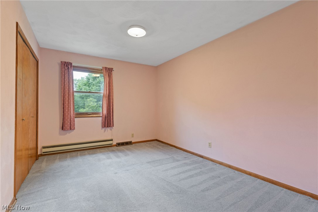 16295 Sperry Road Vermilion, OH 44089 - Photo 25 of 48 Spare room with carpet flooring and baseboard heating