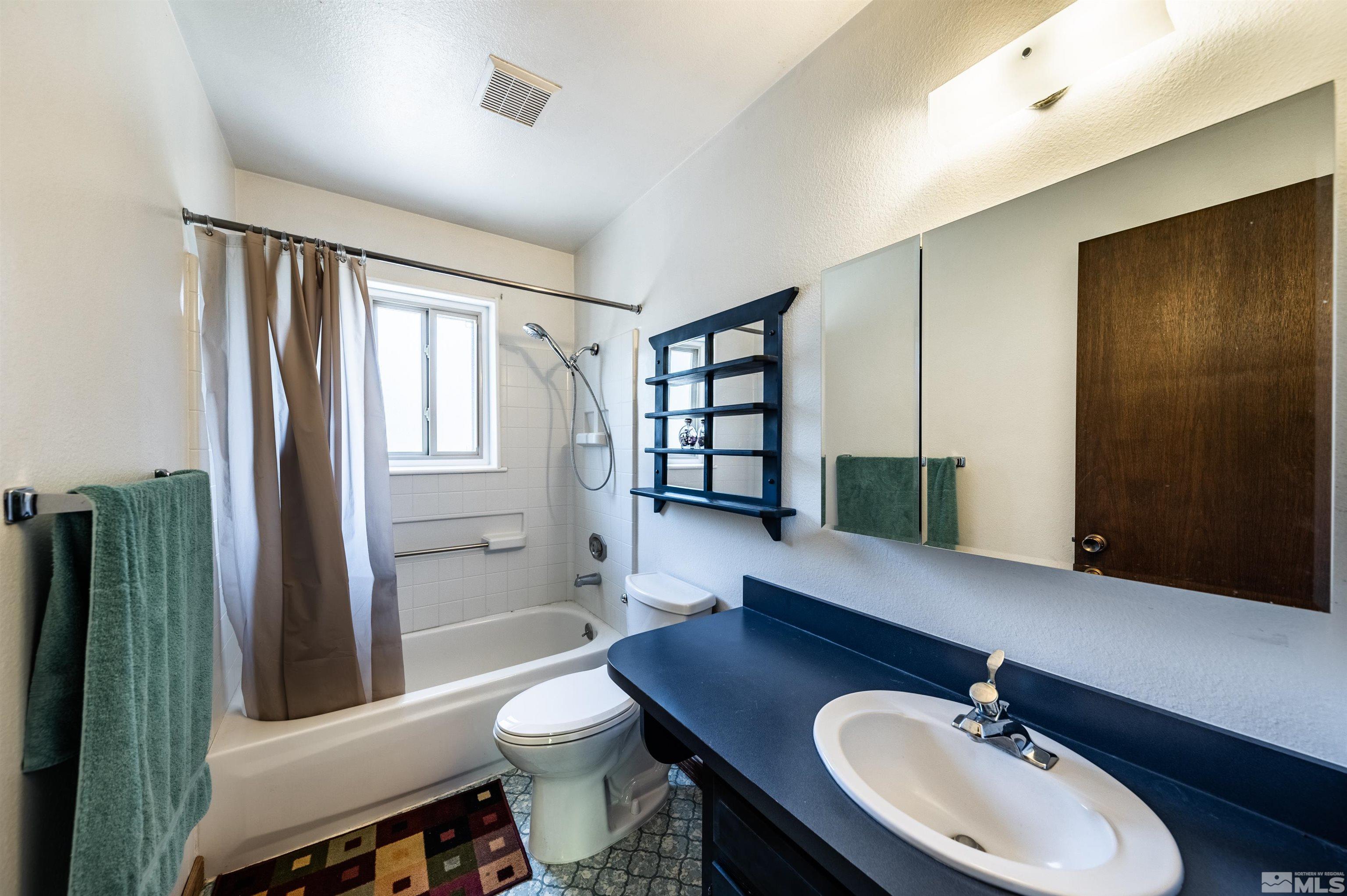 8765 Aquifer Way Reno, NV 89506 - Photo 22 of 39 a bathroom with a sink a toilet and shower
