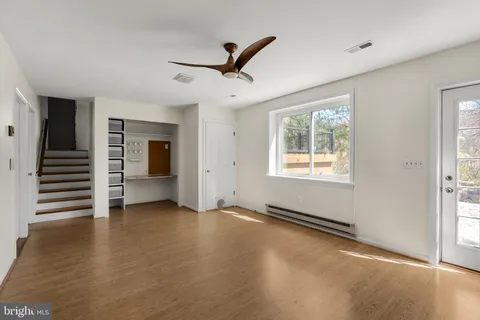 wooden floor in an empty room with a window