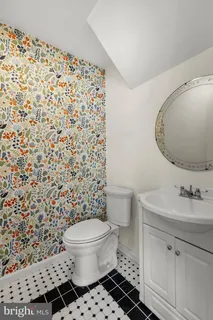 a bathroom with a sink toilet and a mirror