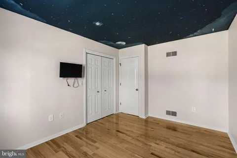 a view of hallway with wooden floor