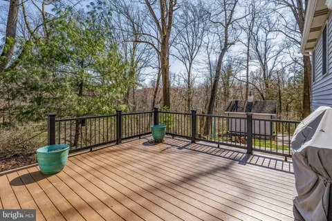 a view of balcony with wooden floor and fence