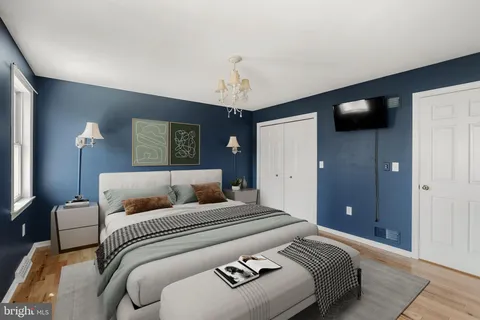a bedroom with a bed and a chandelier