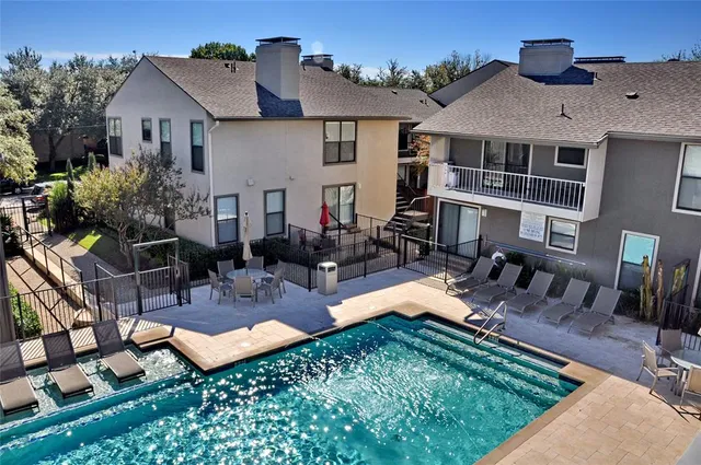 an aerial view of a house with swimming pool garden and patio