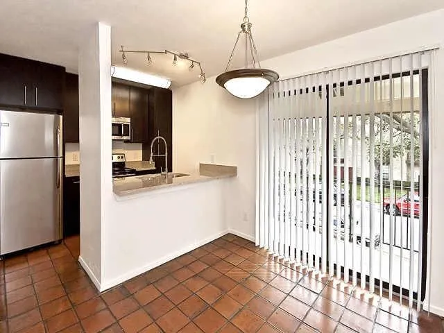 a kitchen with stainless steel appliances a refrigerator and a stove top oven