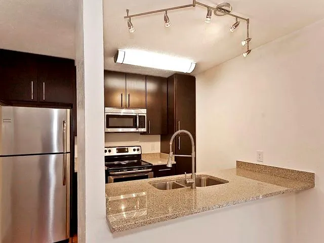 a kitchen with a refrigerator and a sink