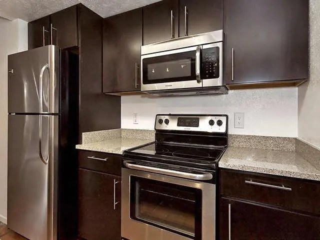 a kitchen with a stove microwave and refrigerator