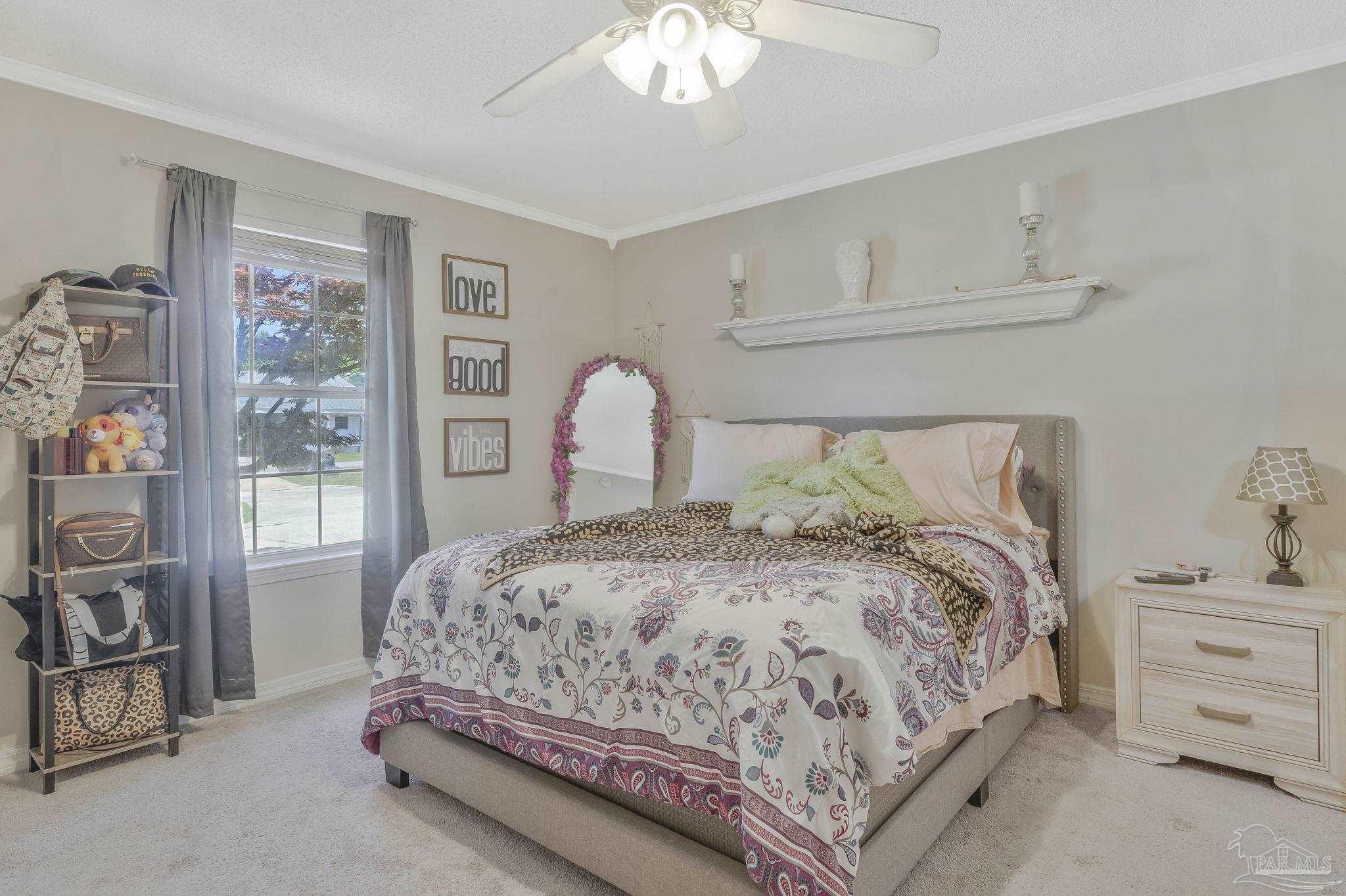 5539 Windrun Place Pace, FL 32571 - Photo 5 of 62 a bedroom with a bed and a chandelier