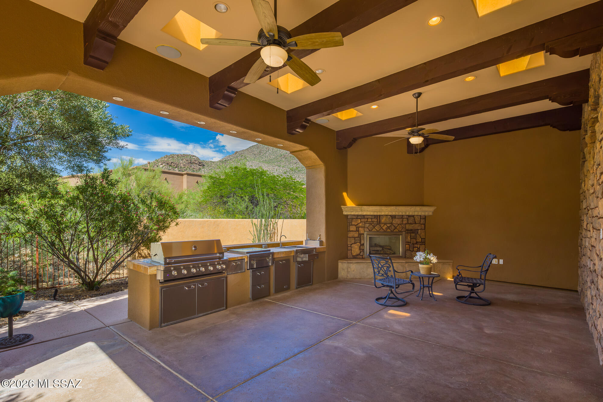 14225 North Rocking Ridge Court Marana, AZ 85658 - Photo 44 of 51 Side patio with outdoor kitchen and fireplace