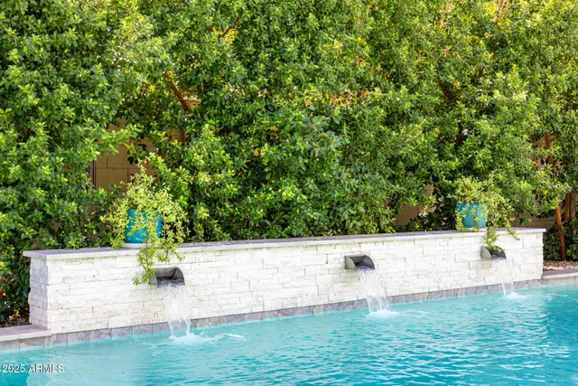 a front view of a house with a yard and potted plants