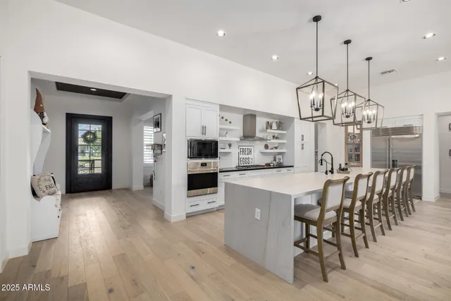 a kitchen with kitchen island stainless steel appliances a sink and cabinets