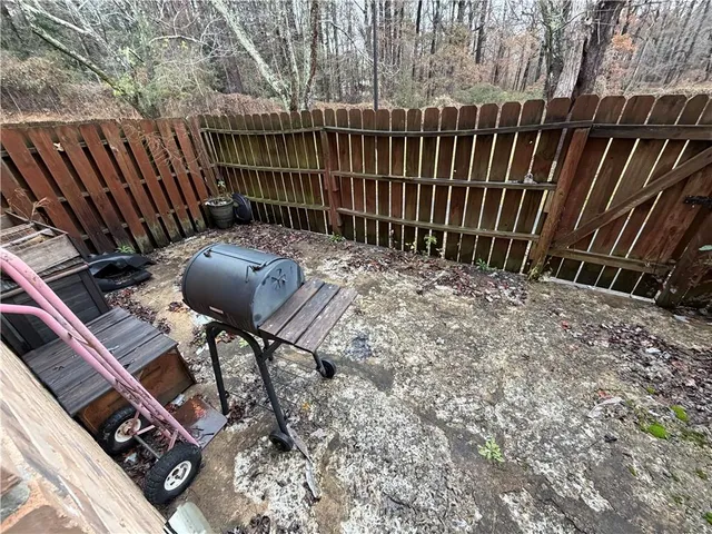 a view of deck with chairs and wooden fence
