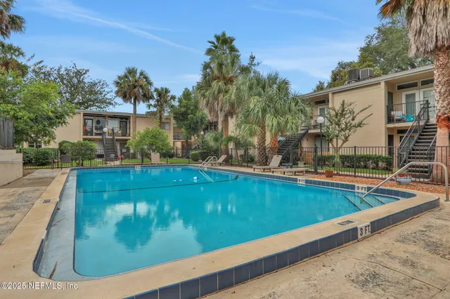 a view of a backyard and a swimming pool
