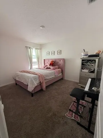 a bedroom with bed and a window