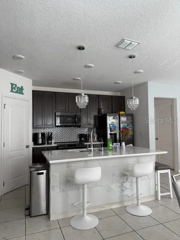 a kitchen with stainless steel appliances kitchen island granite countertop a sink and cabinets
