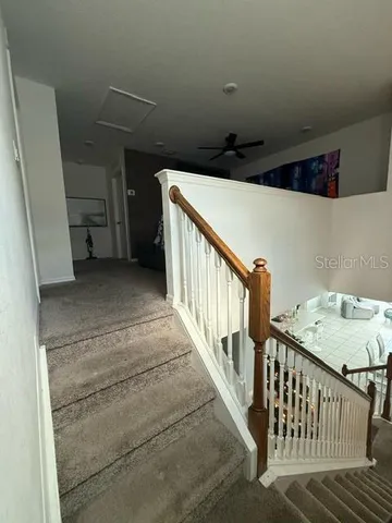 a view of a hallway with stairs