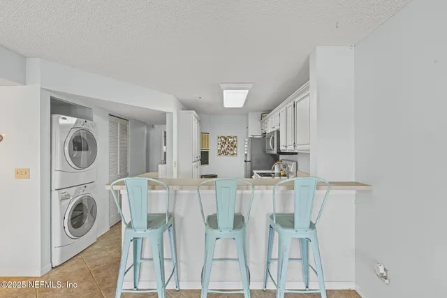 a kitchen with refrigerator a stove a sink and cabinets