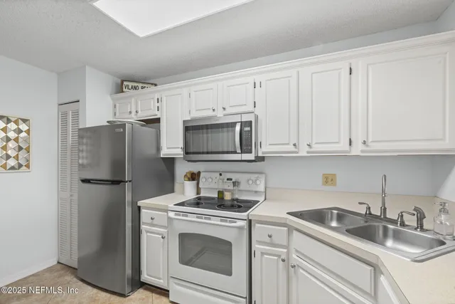 a kitchen with stainless steel appliances a refrigerator and a stove top oven