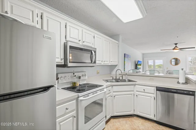 a kitchen with stainless steel appliances granite countertop a sink and cabinets