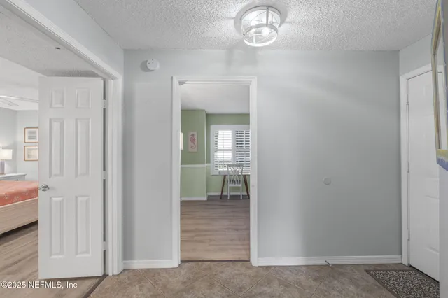 a bed room with a bed and a chair