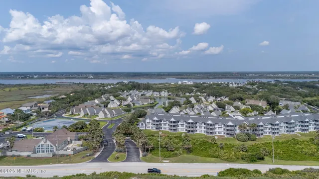 an aerial view of a house with a ocean view