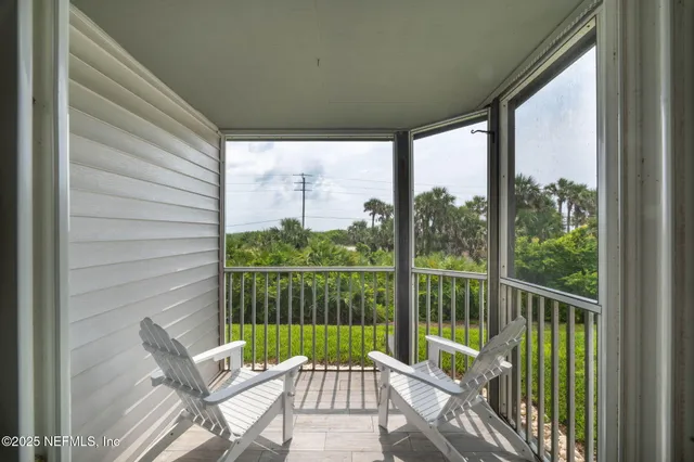 a view of a balcony with chair and wooden floor