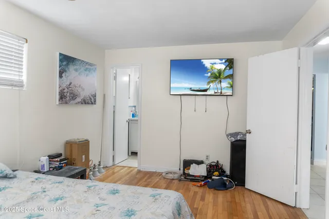 a bedroom with a bed and a view of bathroom