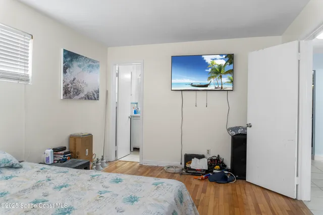 a bedroom with a bed and a view of bathroom