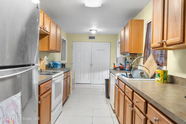 a kitchen with stainless steel appliances granite countertop a sink and a stove