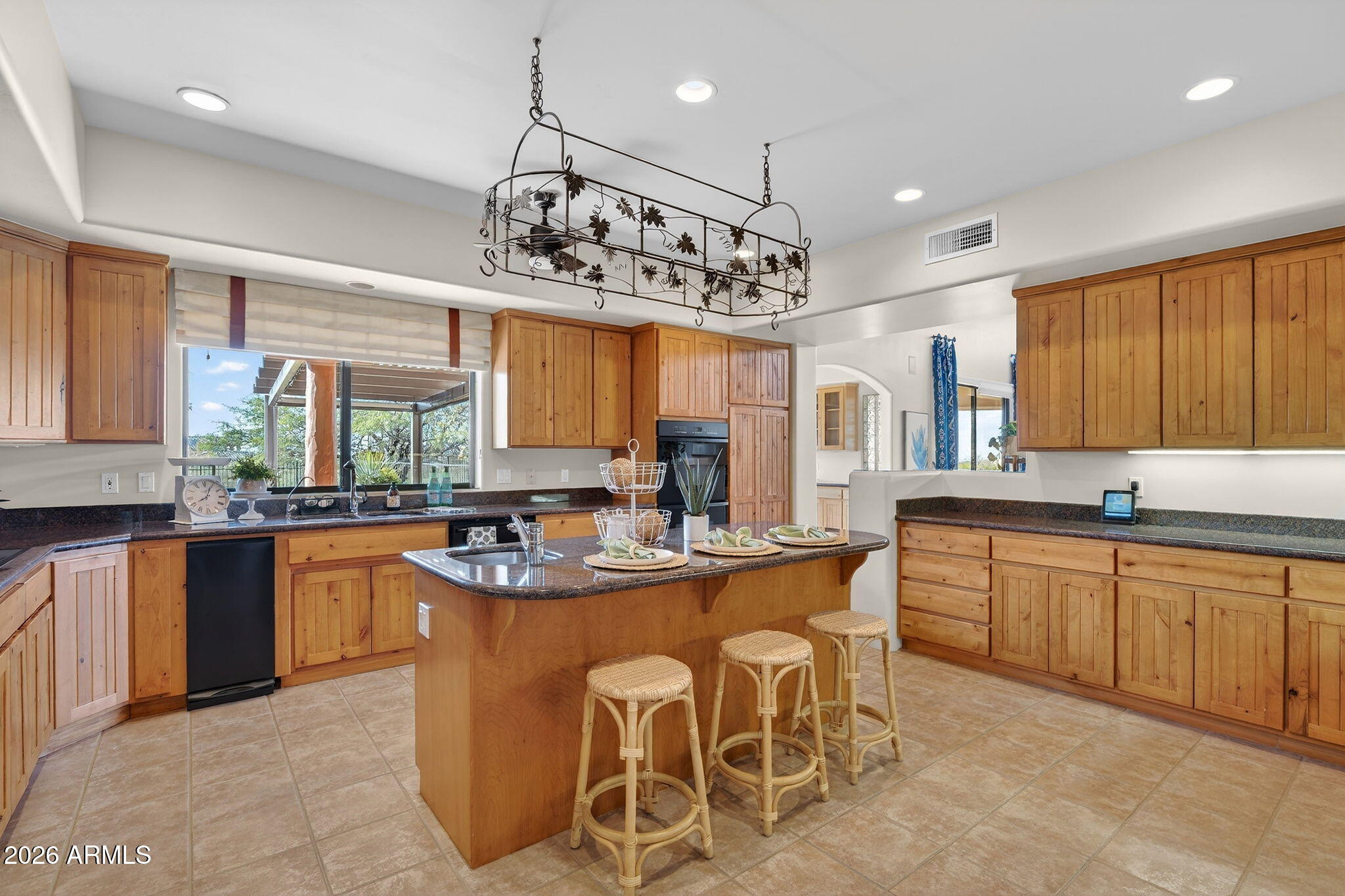 8540 East McDowell Road, Unit 110 Mesa, AZ 85207 - Photo 9 of 74 a kitchen with stainless steel appliances granite countertop counter space a sink and cabinets