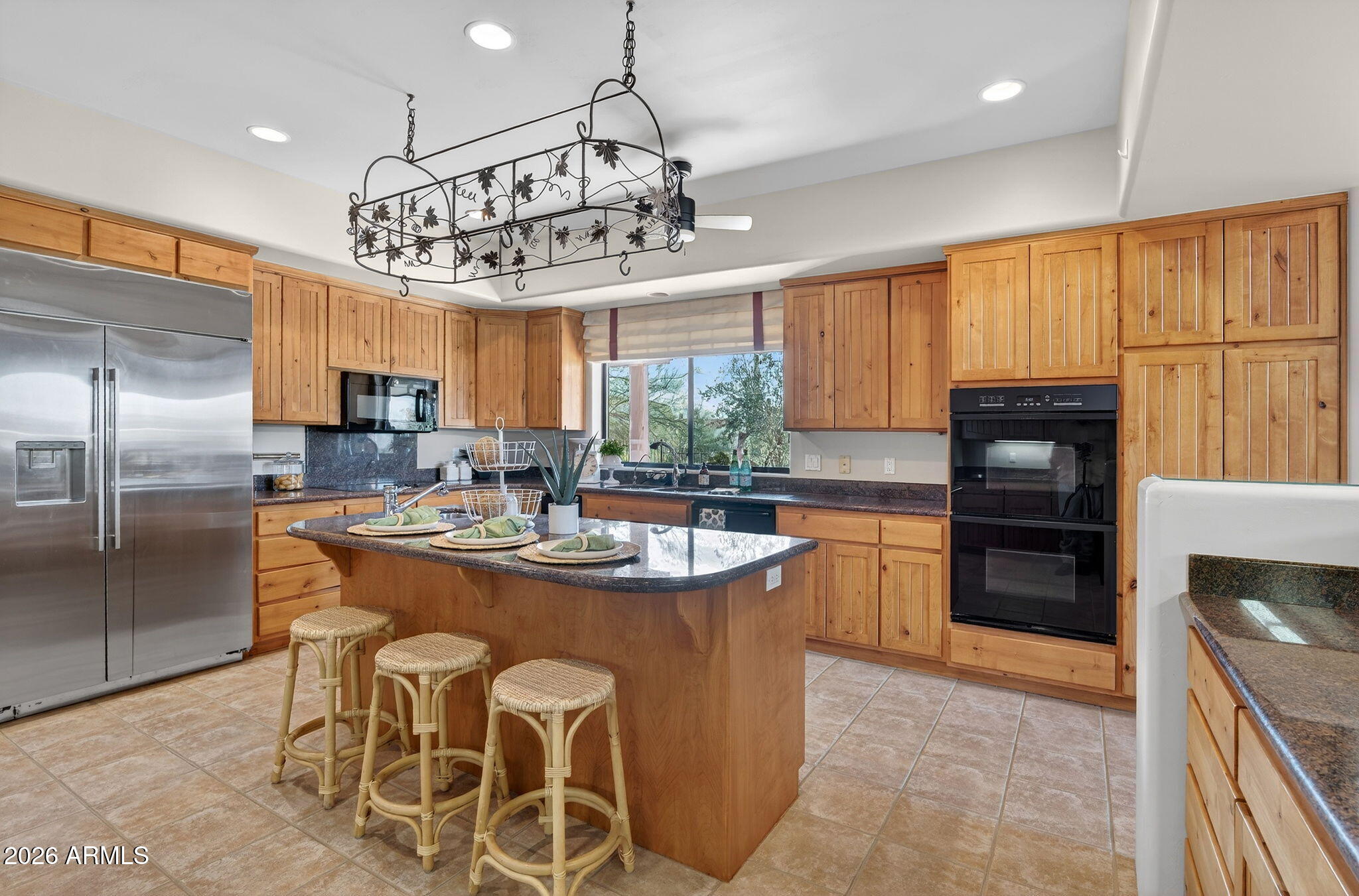 8540 East McDowell Road, Unit 110 Mesa, AZ 85207 - Photo 10 of 74 a kitchen with stainless steel appliances granite countertop a sink a stove a refrigerator cabinets and dining table