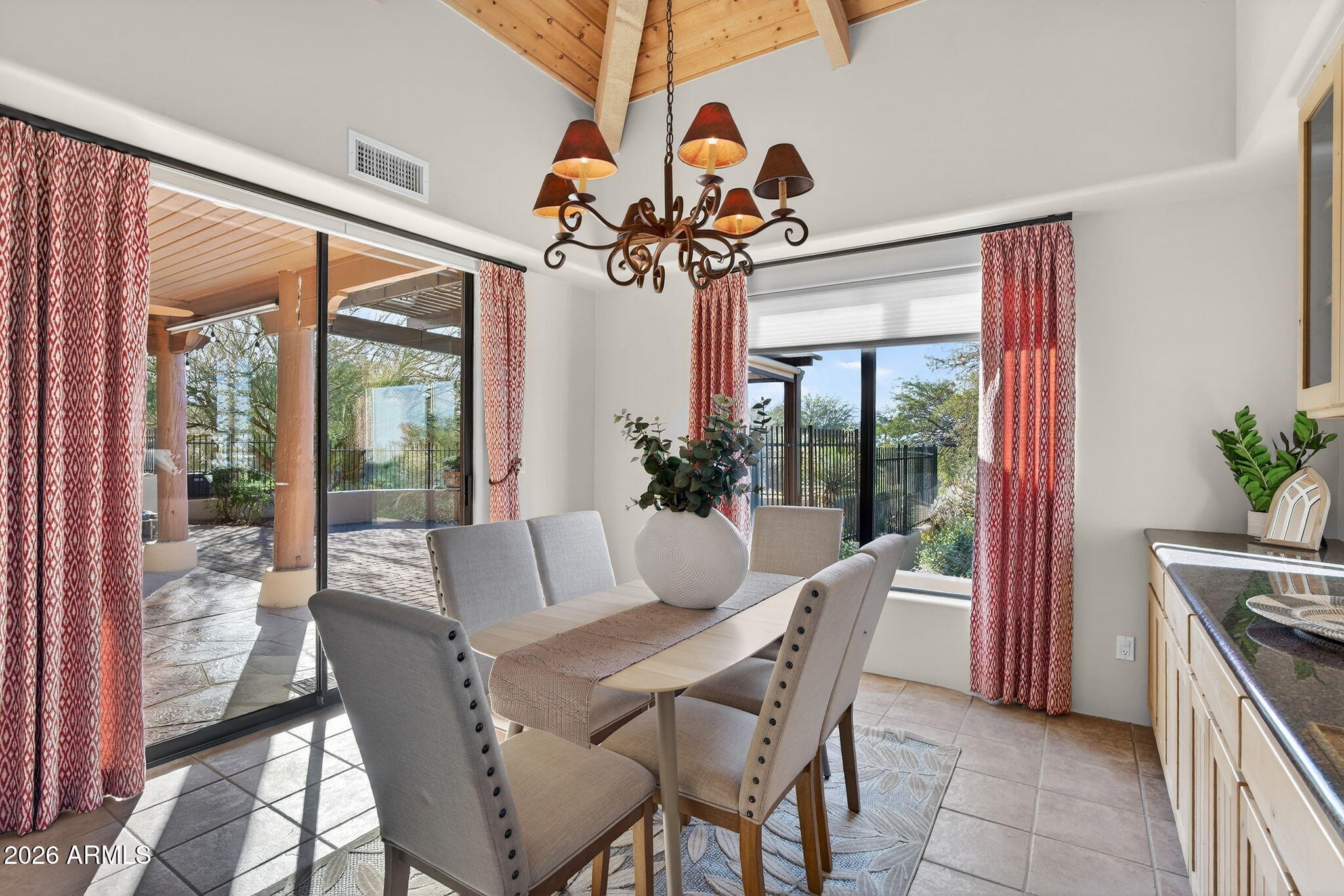 8540 East McDowell Road, Unit 110 Mesa, AZ 85207 - Photo 13 of 74 a dining room with furniture wooden floor a potted plant and a chandelier
