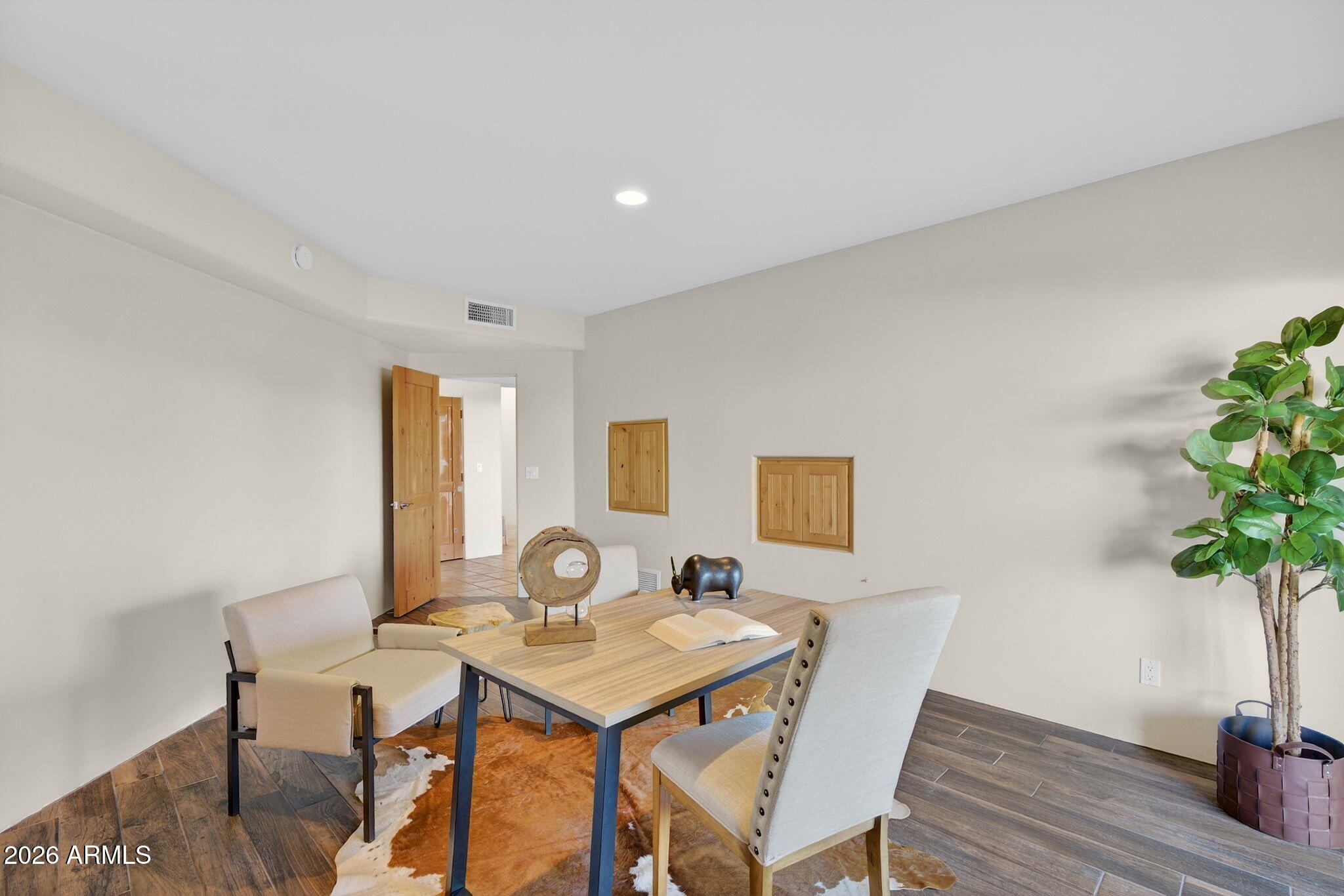 8540 East McDowell Road, Unit 110 Mesa, AZ 85207 - Photo 16 of 74 a view of a dining room with furniture and wooden floor