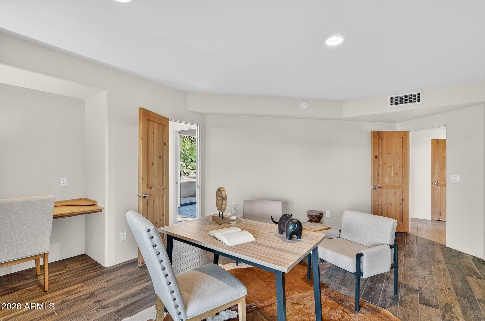 8540 East McDowell Road, Unit 110 Mesa, AZ 85207 - Photo 17 of 74 a view of a dining room with furniture and wooden floor