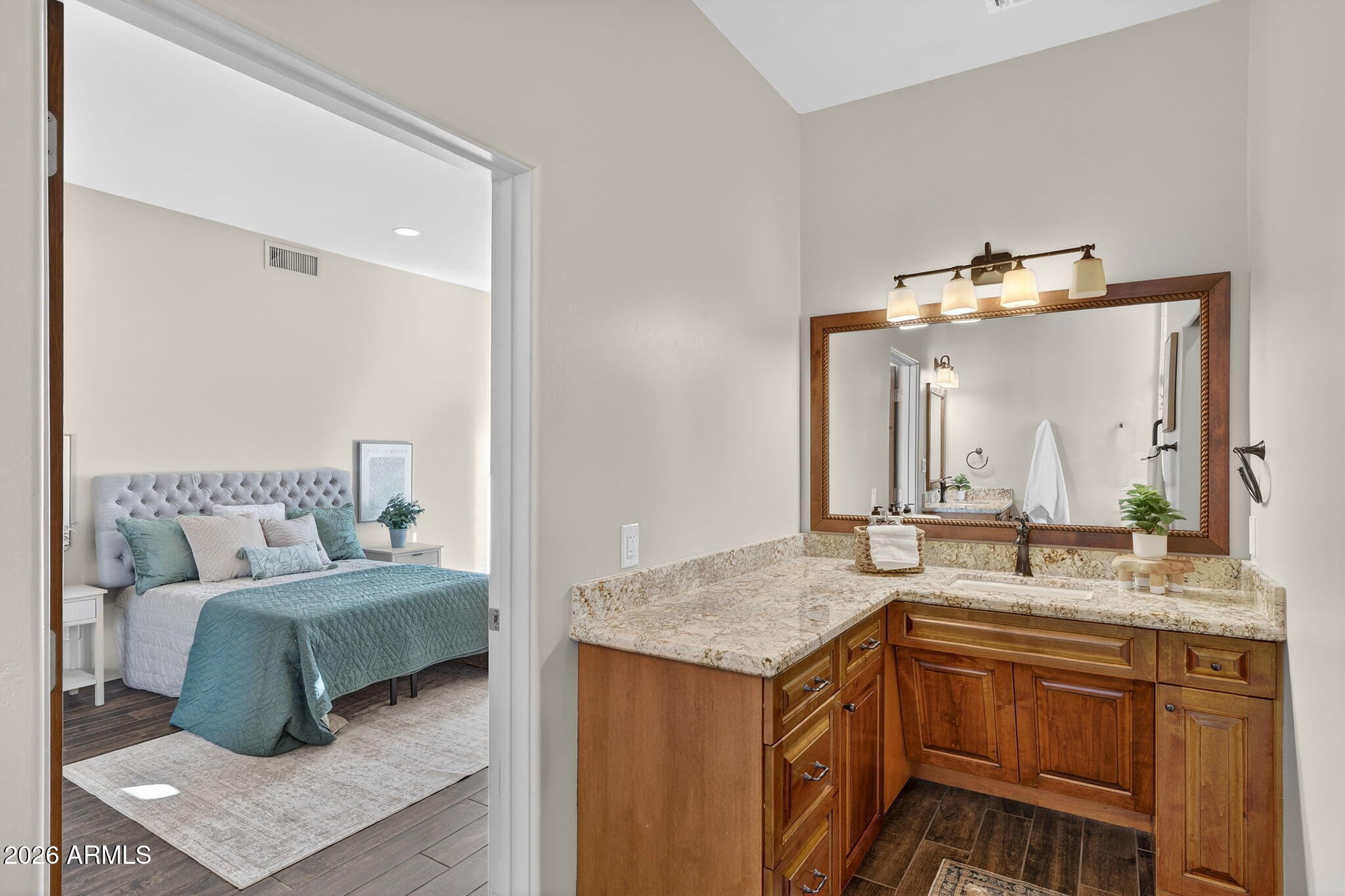 8540 East McDowell Road, Unit 110 Mesa, AZ 85207 - Photo 33 of 74 a en suite bathroom with a granite countertop sink and a mirror