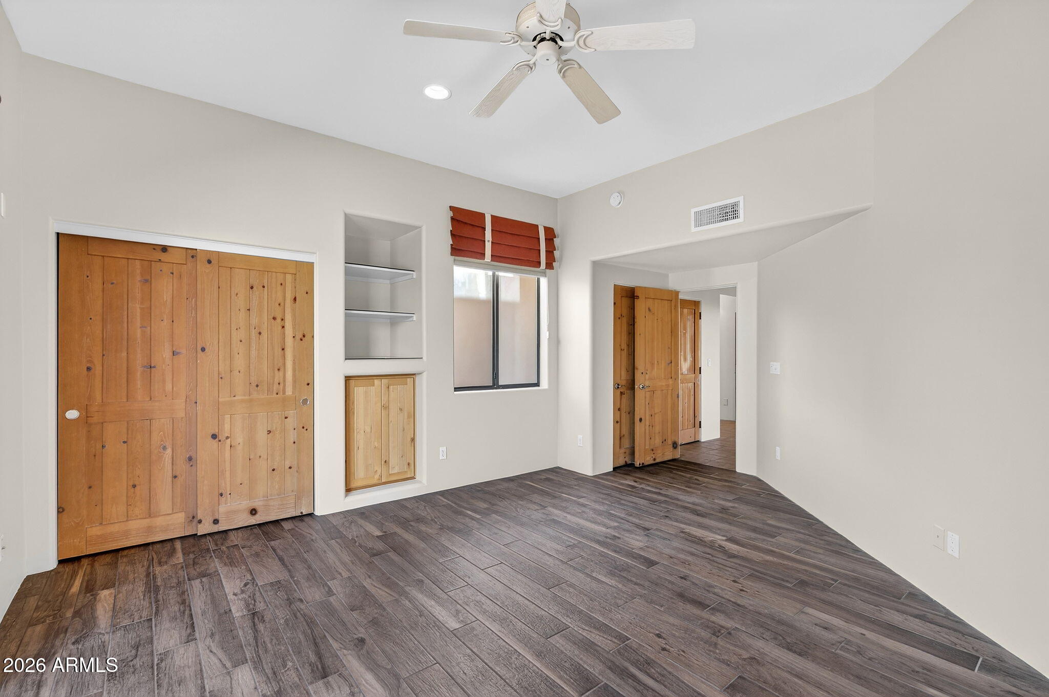 8540 East McDowell Road, Unit 110 Mesa, AZ 85207 - Photo 36 of 74 an empty room with wooden floor closet and windows