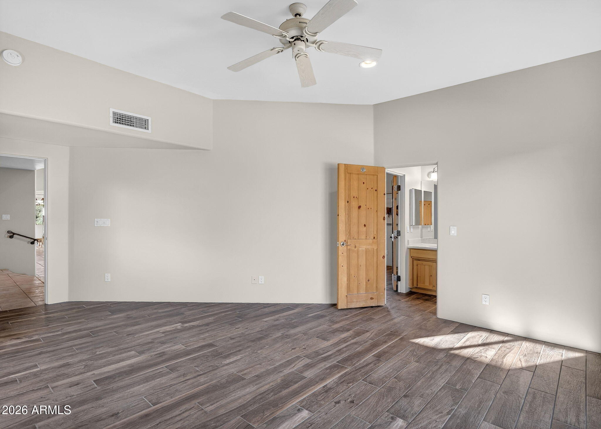 8540 East McDowell Road, Unit 110 Mesa, AZ 85207 - Photo 37 of 74 a view of empty room with wooden floor and ceiling fan