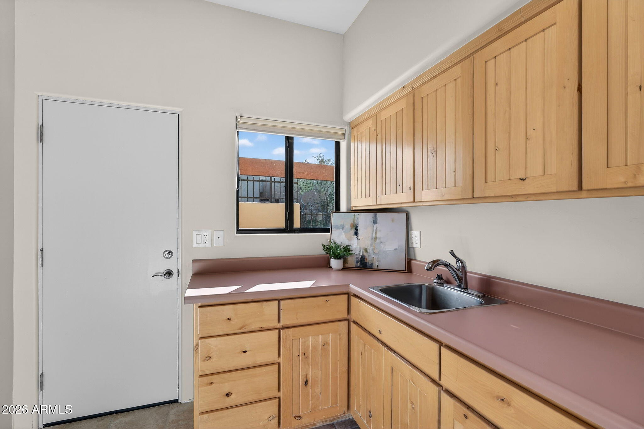 8540 East McDowell Road, Unit 110 Mesa, AZ 85207 - Photo 40 of 74 a kitchen with stainless steel appliances granite countertop white cabinets sink and window