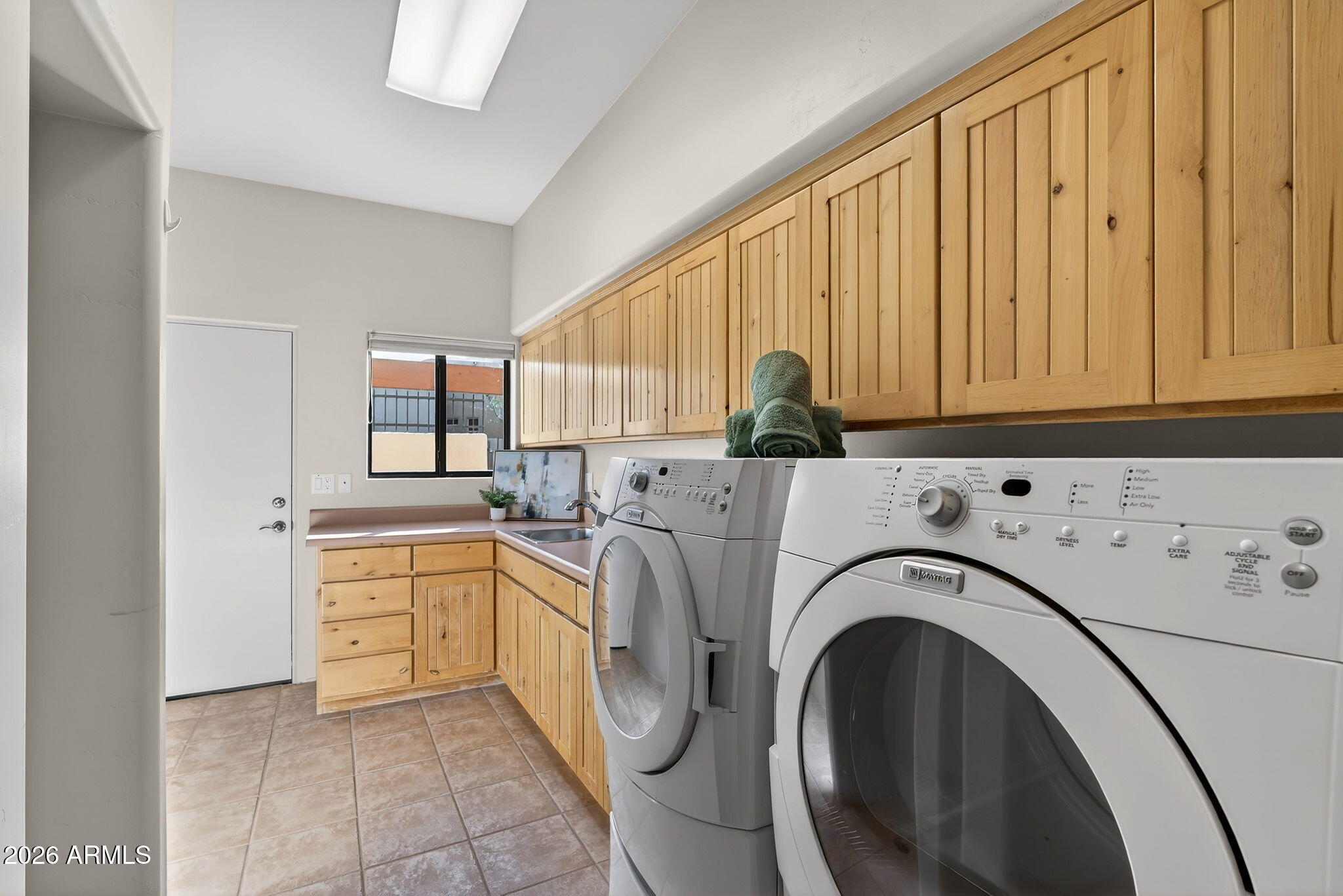 8540 East McDowell Road, Unit 110 Mesa, AZ 85207 - Photo 41 of 74 a utility room with sink dryer and washer