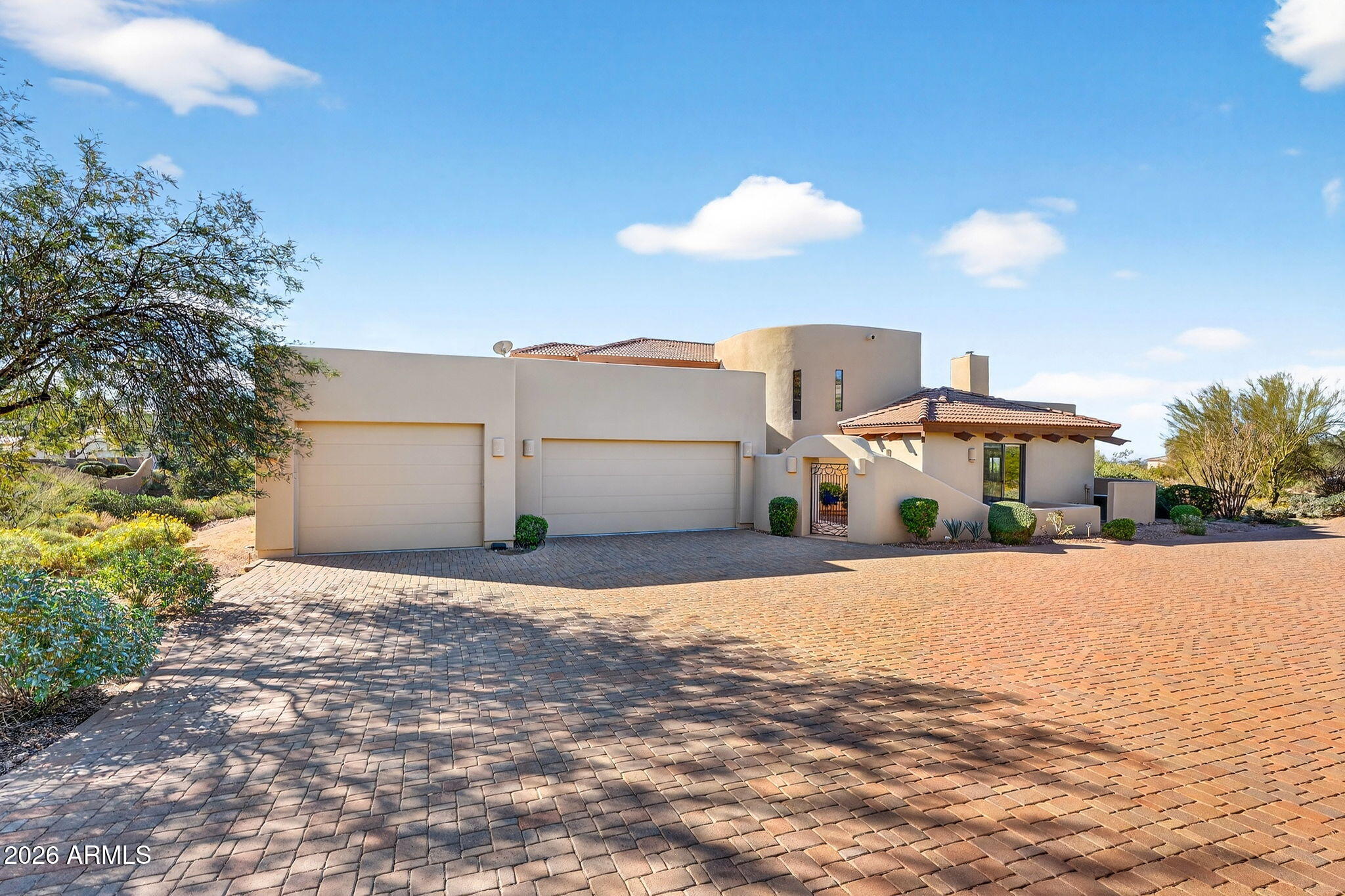 8540 East McDowell Road, Unit 110 Mesa, AZ 85207 - Photo 48 of 74 a front view of a house with a yard and garage