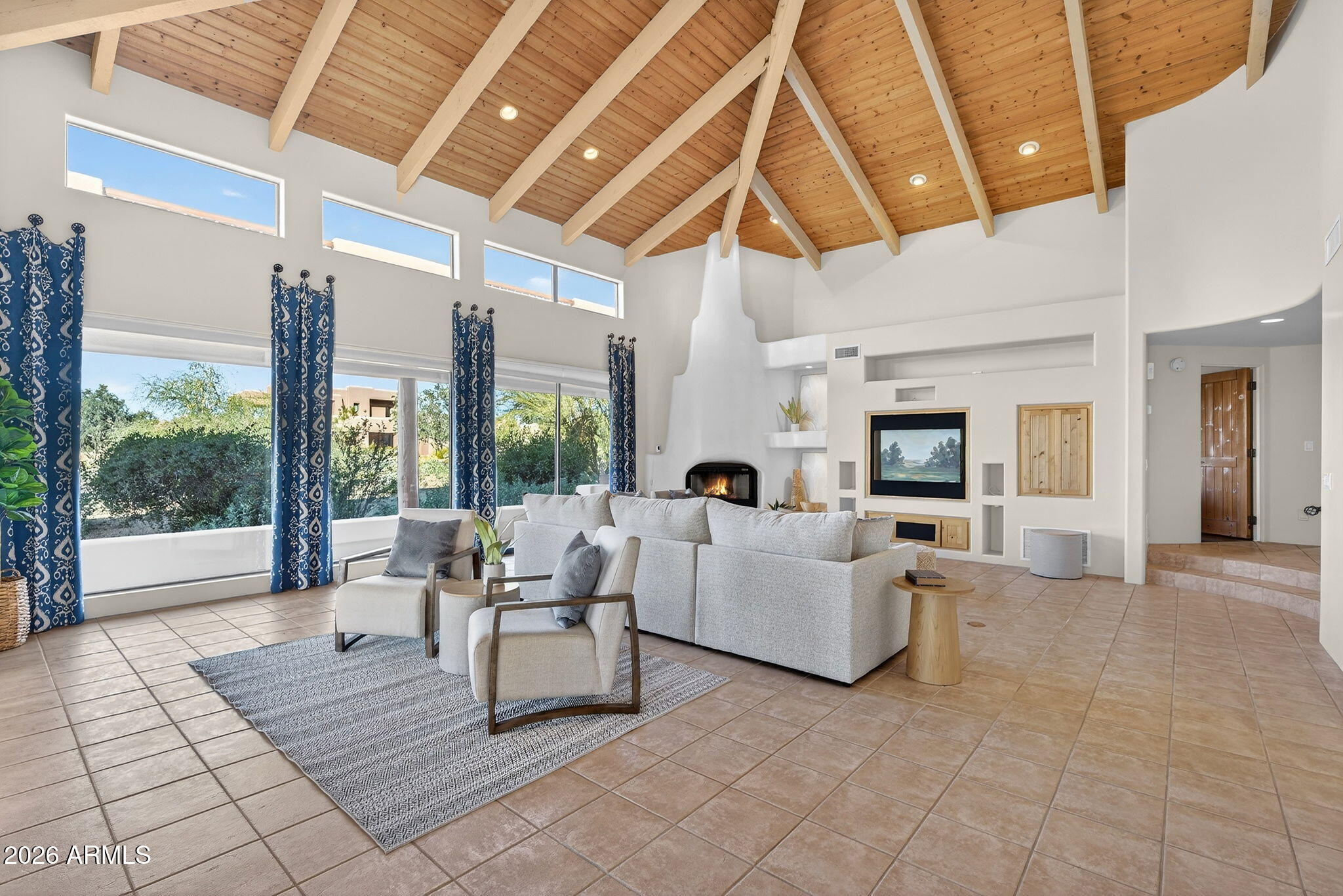 8540 East McDowell Road, Unit 110 Mesa, AZ 85207 - Photo 4 of 74 a living room with furniture and a floor to ceiling window
