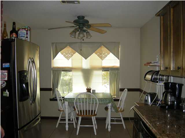 1083 Tallokas Road Crestview, FL 32536 - Photo 13 of 35 a view of a dining room with furniture window and outside view